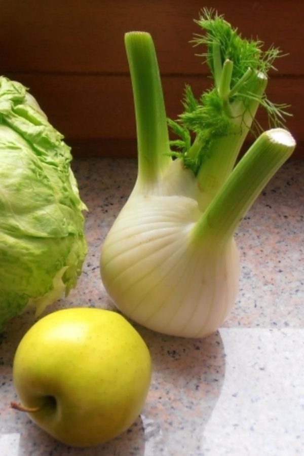 An image of green ingredients for Smoked Mackerel Salad: an Apple, lettuce and fennel.